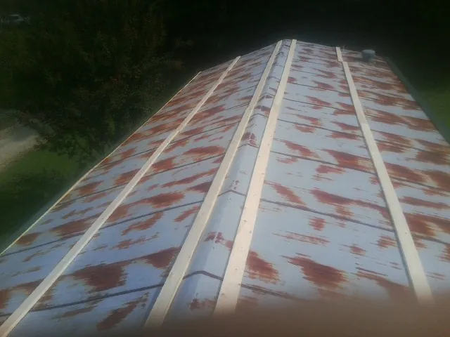Rusted metal roof panels with new wood purlins before replacement — Storm Damage Roof Repair in Carversville by Roofing Brothers